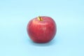 Red yellow apple on a blue background. Juicy ripe beautiful fruit Royalty Free Stock Photo