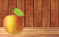 Red and yellow apple fruit with green leaf on wooden table Royalty Free Stock Photo