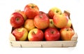 Red and yellow apples in a wooden crate on white background Royalty Free Stock Photo