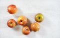 Red / yellow apples kiku variety on white working board, photo from above