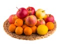 Red and yellow apples, tangerines and lemons on a straw mat