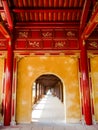 Red and yellow archway gallery at the royal palace in Hue, Vietnam