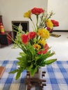 Red yellow artificial flower vass