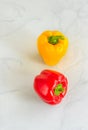 Red and Yellow Bell Peppers / Capsicums on Gray-White Background Royalty Free Stock Photo
