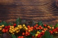 Red, yellow berries on wooden background