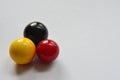 red, yellow and black marbles on white background Royalty Free Stock Photo