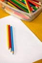 Crayons and paper on the desk Royalty Free Stock Photo