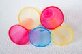 Red, yellow and blue plastic cups lie on a light surface Royalty Free Stock Photo