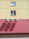 Red-yellow building with three air conditioners