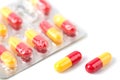 Red and yellow capsule pills in blister isolated