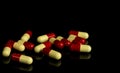 Red, yellow capsule pills on dark background. Antibiotic resi Royalty Free Stock Photo