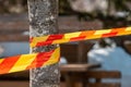 Red and yellow caution tape as a warning and marking of protected area Royalty Free Stock Photo