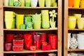 Red and yellow ceramic flowerpots in the florist store