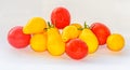 Red and yellow cherry tomato fruits, plant Solanum lycopersicum, white background, close up Royalty Free Stock Photo