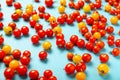 Red and yellow cherry tomatoes on blue background. Fresh bright organic vegetables Royalty Free Stock Photo