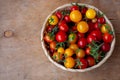 Red and yellow cherry tomatoes bowl top view. Harvest vegetables. Tomato on the table. Vitamin healthy food. Rustic wooden Royalty Free Stock Photo