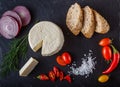 Red and yellow cherry tomatoes on slate with sliced bread, onion Royalty Free Stock Photo