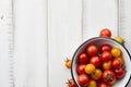 Red and yellow cherry tomatoes on white wooden table Royalty Free Stock Photo