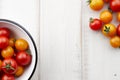 Red and yellow cherry tomatoes on white wooden table Royalty Free Stock Photo