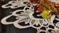 red and yellow Christmas garland, white lace tablecloth Royalty Free Stock Photo