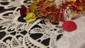 red and yellow Christmas garland, white lace tablecloth Royalty Free Stock Photo