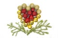 Red yellow Christmas tree balls in the form of a heart with green spruce branches isolated on a white background. Toys, New year Royalty Free Stock Photo