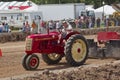 Red & Yellow Cockshutt Tractor pulling Tracks Royalty Free Stock Photo