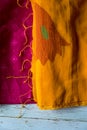Red and yellow cotton sari displayed on top of another Royalty Free Stock Photo