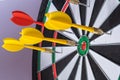 Red and yellow dart arrows hitting in the target center of dartboard. Success hitting target aim goal achievement concept Royalty Free Stock Photo