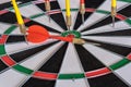 Red and yellow dart arrows hitting in the target center of dartboard. Success hitting target aim goal achievement concept Royalty Free Stock Photo