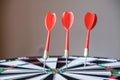 Red and yellow dart arrows hitting in the target center of dartboard. Success hitting target aim goal achievement concept Royalty Free Stock Photo