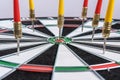 Red and yellow dart arrows hitting in the target center of dartboard. Success hitting target aim goal achievement concept Royalty Free Stock Photo