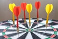 Red and yellow dart arrows hitting in the target center of dartboard. Success hitting target aim goal achievement concept Royalty Free Stock Photo