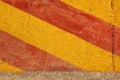 Red yellow diagonal warning stripes on weathered concrete wall Royalty Free Stock Photo