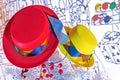 Red and yellow felt hats on a white Christmas tree. Bright french hats