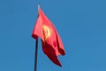 The red and yellow flag of Kyrgyzstan flying over Ala Too Square in Bishkek, the capital city