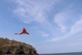 Red-yellow flying kite in the wind. Colorful toy with dragon head for amusement of children. Manual production. Hand made. Royalty Free Stock Photo