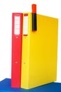 Red and yellow folders on a blue one Royalty Free Stock Photo