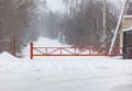 A red and yellow gate is in the snow Royalty Free Stock Photo