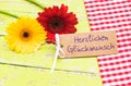 Colorful flowers and greeting card with german text, Herzlichen Glueckwunsch, means congratulation