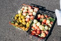 Red, yellow, green apples in basket and box stand on asphalt for sale outdoors, top view Royalty Free Stock Photo