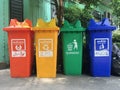 Red yellow green and blue, recycle bins with recycle symbol near building outdoor. Royalty Free Stock Photo