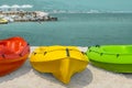 Red, yellow and green kayaks on white sand on the beach of Cyprus against the backdrop of the sea and umbrellas on the coast Royalty Free Stock Photo