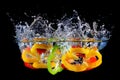 Red yellow and green pepper slices fall into water, on black background Royalty Free Stock Photo