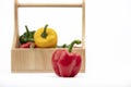 Red, Yellow, Green Peppers in wooden basket Royalty Free Stock Photo