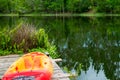 Close Up Of Kayak On Pier Beside Large Forested Lake