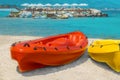Red and yellow kayaks on white sand on the beach of Cyprus against the backdrop of the sea and umbrellas on the coast Royalty Free Stock Photo