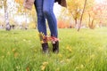 Red and yellow leaves tucked into boots for a walk in the park.deporsonalization