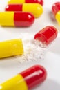 red and yellow open pills on white background, health and nature, top view, copy space Royalty Free Stock Photo