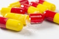 red and yellow open pills on white background, health and nature, top view, copy space Royalty Free Stock Photo